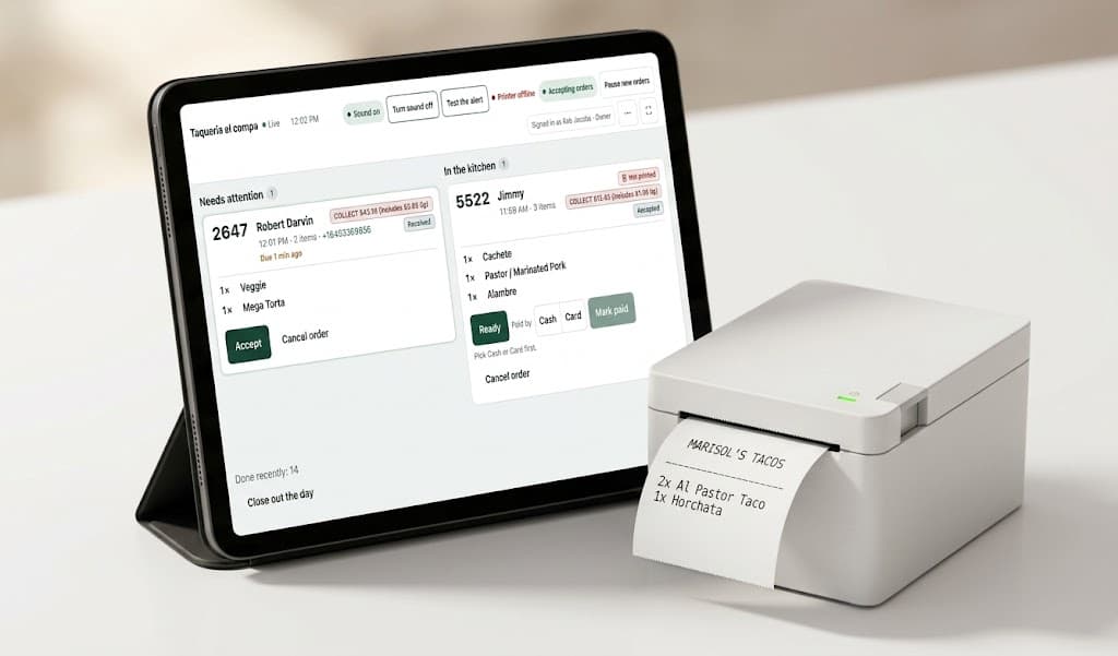 A tablet showing the restaurant's live order queue on the counter, next to a receipt printer printing a kitchen ticket.